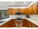 Close up of a kitchen with wooden cabinets, stainless steel appliances, and white countertops, enhancing functionality at 170 Mark Nw Trl, Sandy Springs, GA 30328