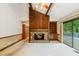 Open living room with a stone fireplace, built-in shelving, and large sliding doors to a deck at 170 Mark Nw Trl, Sandy Springs, GA 30328