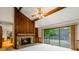 Inviting living room featuring a stone fireplace, wood paneling, and sliding glass doors to the deck at 170 Mark Nw Trl, Sandy Springs, GA 30328