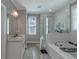 Bright bathroom with double vanity sinks and glass shower door at 1914 Coal Pl, Atlanta, GA 30318