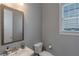 Powder room with a modern sink, toilet, and window at 1914 Coal Pl, Atlanta, GA 30318