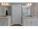 Bright bathroom with double vanity sinks and glass shower door at 1914 Coal Pl, Atlanta, GA 30318