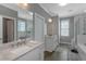Bright bathroom featuring double sinks with white cabinets and a large framed mirror at 1914 Coal Pl, Atlanta, GA 30318