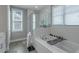 Glass-enclosed shower and separate soaking tub featuring white subway tile at 1914 Coal Pl, Atlanta, GA 30318