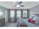 Comfortable bedroom with three windows, ceiling fan, and neutral colored walls at 1914 Coal Pl, Atlanta, GA 30318