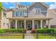 Charming two-story home with covered front porch, manicured lawn, and well-maintained landscaping at 1914 Coal Pl, Atlanta, GA 30318