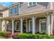 Inviting front porch with stylish columns, seating, and a well-maintained garden at 1914 Coal Pl, Atlanta, GA 30318