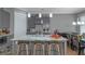 Modern kitchen with grey cabinets, stainless appliances, island with seating, and adjacent dining area at 1914 Coal Pl, Atlanta, GA 30318