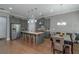 Spacious kitchen with grey cabinetry, stainless appliances, center island, and dining table with chairs at 1914 Coal Pl, Atlanta, GA 30318