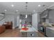 Open kitchen features grey cabinets, stainless steel appliances, and center island with a white countertop at 1914 Coal Pl, Atlanta, GA 30318