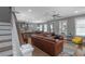 Bright living room with hardwood floors, staircase, sofa, and an adjacent kitchen area at 1914 Coal Pl, Atlanta, GA 30318