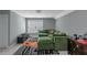 Spacious living room featuring plush green sectional, modern rug, and neutral wall color at 1914 Coal Pl, Atlanta, GA 30318