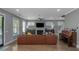 Bright living room with hardwood floors, a large leather sofa, fireplace, and multiple windows at 1914 Coal Pl, Atlanta, GA 30318