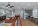 Open-concept living space with a leather sofa, hardwood floors, piano, and view of the modern kitchen at 1914 Coal Pl, Atlanta, GA 30318