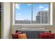 Bright living room area with red pillows and nice city view at 2479 Peachtree Rd # 601, Atlanta, GA 30305