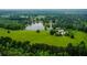 This elevated shot exhibits the verdant landscaping and private pond featured at this magnificent property at 1415 N Flat Rock Rd, Douglasville, GA 30134