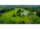 Stunning aerial view of estate with pool, lush greenery, and a tranquil pond at 1415 N Flat Rock Rd, Douglasville, GA 30134