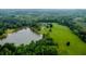 An aerial view showcases the manicured lawns and water features that surround this sprawling home at 1415 N Flat Rock Rd, Douglasville, GA 30134