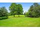 Expansive backyard featuring mature trees and lush green lawn at 1415 N Flat Rock Rd, Douglasville, GA 30134