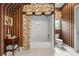 Bathroom featuring a shower-tub, decorative wallpaper, and ample space, combining functionality with style at 1415 N Flat Rock Rd, Douglasville, GA 30134