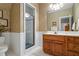 Bathroom features a glass enclosed shower, vanity with storage, and decorative wallpaper at 1415 N Flat Rock Rd, Douglasville, GA 30134
