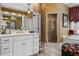 Bathroom showcasing a spacious vanity with double sinks, gold accents and a separate glass-enclosed shower at 1415 N Flat Rock Rd, Douglasville, GA 30134