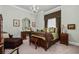 Elegant bedroom with detailed bedframe, classic chandelier, and complementary decor, creating a tranquil retreat at 1415 N Flat Rock Rd, Douglasville, GA 30134