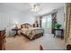 Bright bedroom with large windows, neutral carpet, and coordinated furnishings for a cozy, inviting atmosphere at 1415 N Flat Rock Rd, Douglasville, GA 30134