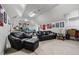 A spacious bonus room offers multiple seating options, a ping pong table, and natural light at 1415 N Flat Rock Rd, Douglasville, GA 30134