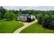 Beautiful home with manicured lawn, mature trees, and a winding driveway at 1415 N Flat Rock Rd, Douglasville, GA 30134