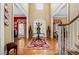Elegant foyer with hardwood floors, ornate rug, and staircase, showcasing the home's grand entrance and design at 1415 N Flat Rock Rd, Douglasville, GA 30134