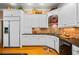 Contemporary kitchen featuring white cabinets, granite counters, and modern appliances at 1415 N Flat Rock Rd, Douglasville, GA 30134