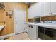 Functional laundry room with white cabinets, modern washer and dryer, and ample counter space at 1415 N Flat Rock Rd, Douglasville, GA 30134