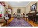 Cozy living room featuring classic furnishings, a vintage piano, and elegant decor, creating a warm and inviting space at 1415 N Flat Rock Rd, Douglasville, GA 30134
