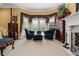 Elegant main bedroom with sitting area, fireplace, and large windows for a bright and airy feel at 1415 N Flat Rock Rd, Douglasville, GA 30134
