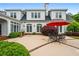 The patio of this home offers ample space for outdoor dining and entertaining beneath a bright red umbrella at 1415 N Flat Rock Rd, Douglasville, GA 30134