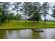 Scenic view of the pond with a dock and the home in the background at 1415 N Flat Rock Rd, Douglasville, GA 30134