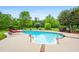 Backyard featuring in-ground pool, poolside seating, and mature trees for added privacy at 1415 N Flat Rock Rd, Douglasville, GA 30134