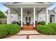 A covered outdoor living space offers a ceiling fan and comfortable seating for relaxing and grilling at 1415 N Flat Rock Rd, Douglasville, GA 30134