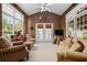 Bright sun room with vaulted ceilings, large windows, and comfortable seating area at 1415 N Flat Rock Rd, Douglasville, GA 30134