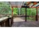 Outdoor deck with wood railing, ceiling fan, overhead lighting, and wooded view at 1615 Mount Mckinley Dr, Grayson, GA 30017