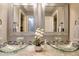 Bright bathroom with glass bowl sinks, stone tile countertops, and decorative framed mirrors at 1615 Mount Mckinley Dr, Grayson, GA 30017