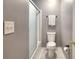 Cozy bathroom featuring a tub with shower, toilet, towel rack, and gray walls at 1615 Mount Mckinley Dr, Grayson, GA 30017