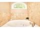 Bathroom featuring tub, tile surround, and window providing natural light at 1615 Mount Mckinley Dr, Grayson, GA 30017