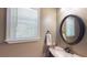 Powder room featuring modern sink, oval mirror and window providing natural light at 1615 Mount Mckinley Dr, Grayson, GA 30017