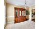 Dining room with an elegant hutch, chandelier, and views to the kitchen at 1615 Mount Mckinley Dr, Grayson, GA 30017