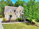 Inviting two-story home with manicured lawn, garden beds and a walkway leading up to the covered front porch at 1615 Mount Mckinley Dr, Grayson, GA 30017