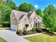Charming home featuring a well-maintained lawn, mature trees, and a convenient driveway leading to an attached garage at 1615 Mount Mckinley Dr, Grayson, GA 30017