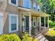 Elegant porch featuring decorative columns, iron railings and a front door surrounded by sidelight windows at 1615 Mount Mckinley Dr, Grayson, GA 30017