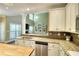 Modern kitchen featuring granite countertops, stainless steel appliances, and a seamless transition to the living area at 1615 Mount Mckinley Dr, Grayson, GA 30017